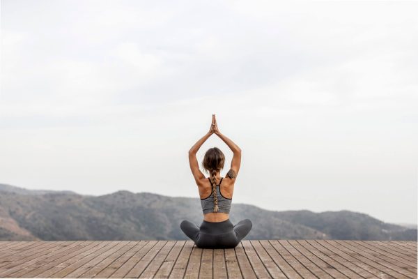 back-view-woman-doing-yoga-outdoors-scaled